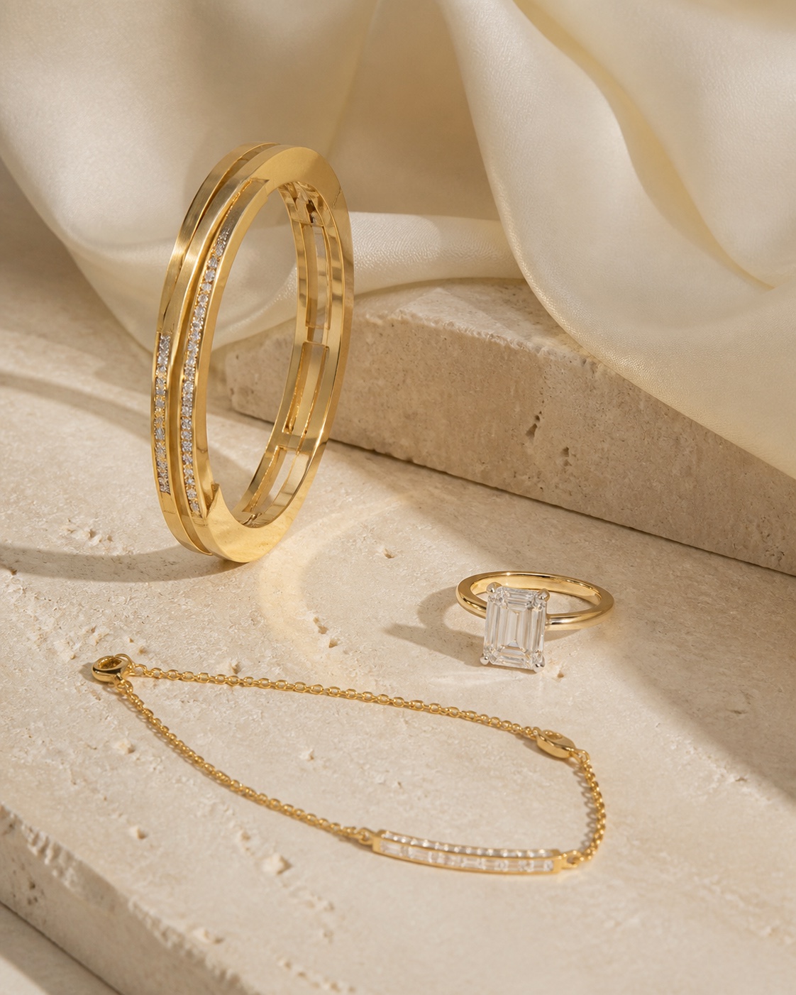 Fine gold and diamond jewellery arranged on ivory stone